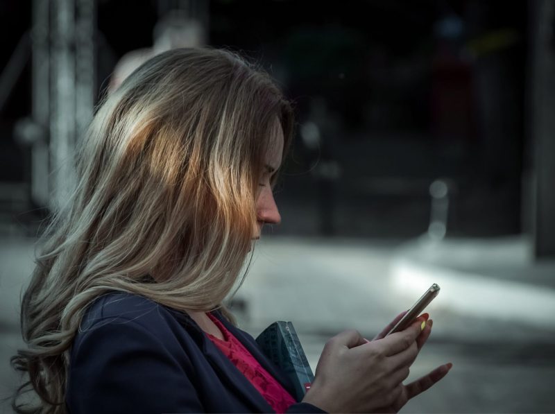woman looking at phone