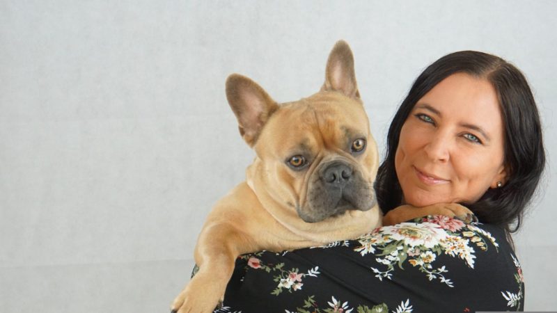 woman hold frenchie dog