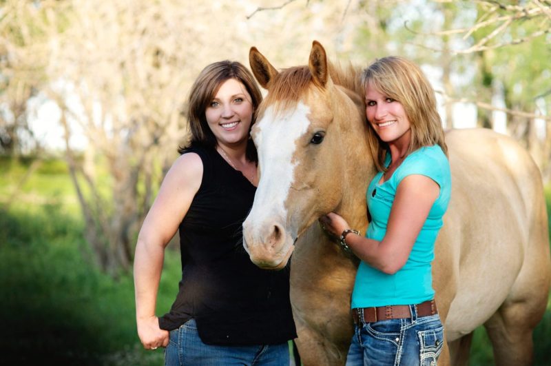 two women with horse in the middle