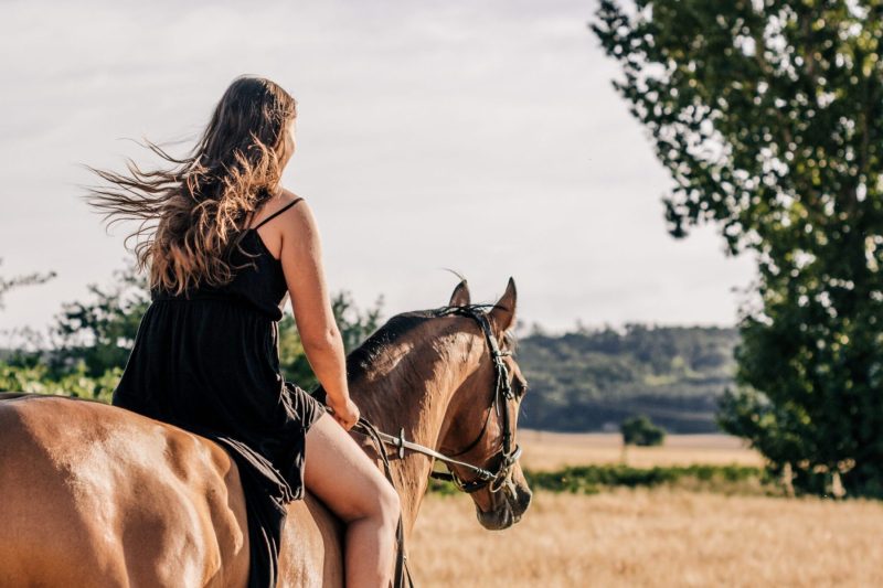 Young woman riding horse off at angle watts mccarthy