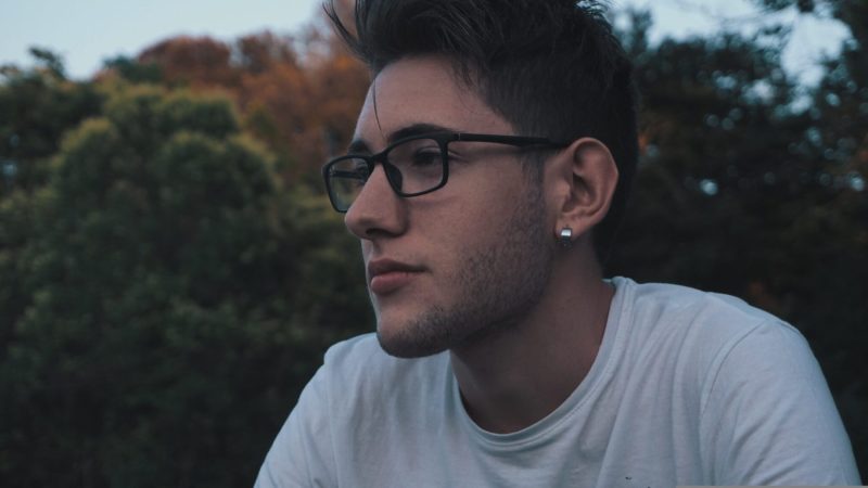 30 year old man with earing with landscape background