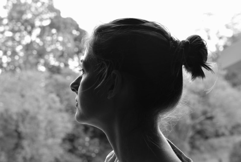 woman with man bun looking left pair with man