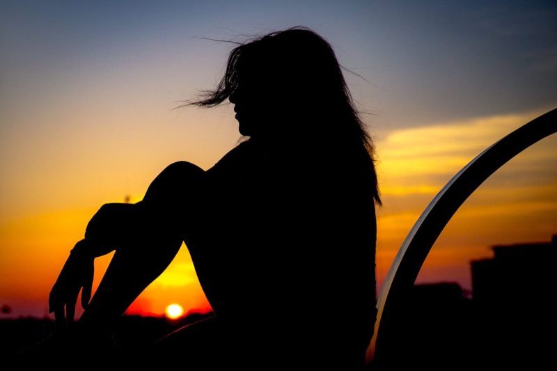 silhouette of woman at sunset looking left pair with man
