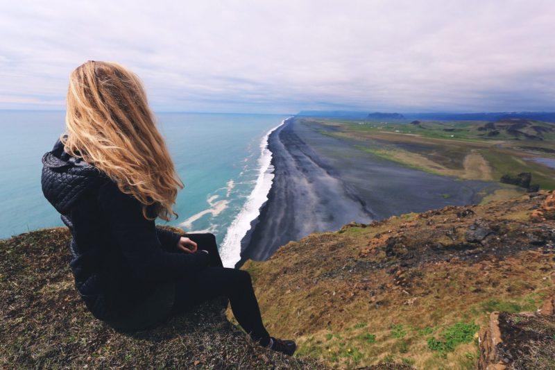 Woman on bluff overlooking the beach fahlen ryan